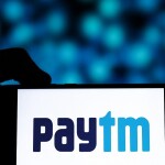 Hand holding a phone with Paytm Logo on screen  - image related to impact of Paytm's RBI restrictions on your daily life