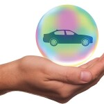 Car in a bubble hovering over a palm