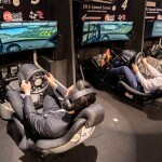 people sitting on a esport simulator playing a racing game – the image tries to explain the India's Esports Explosion