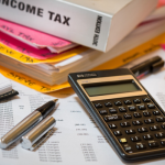 income tax, books, pen, calculator