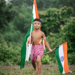 boy carrying Indian flags