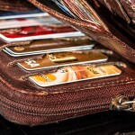 a pouch full of credit cards denoting Delinquencies in Credit Cards and Personal Loans